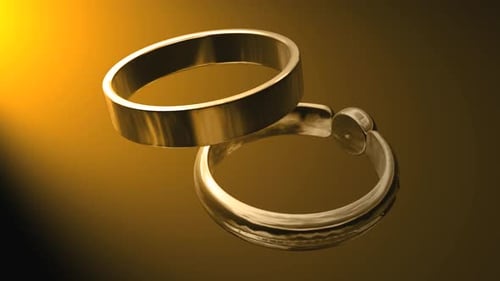 Animated Golden Wedding Rings Spin on Reflective Surface