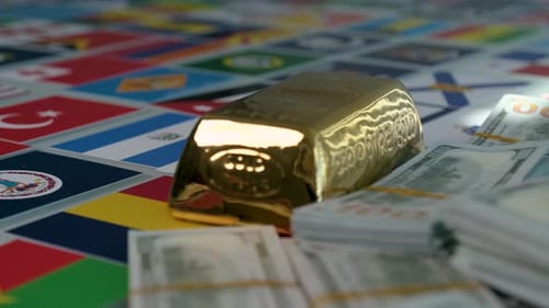 Gold Bar and Money on a Surface of World Flags