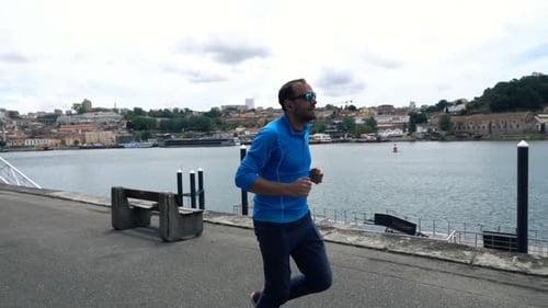 Young Man Jogging in City Near River, Super 120