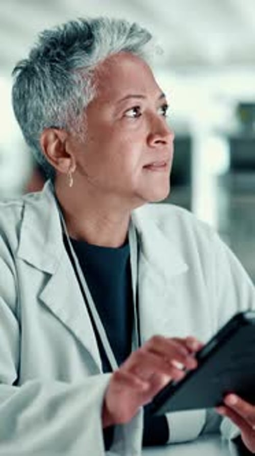 Woman Doctor Using Tablet in Hospital Setting