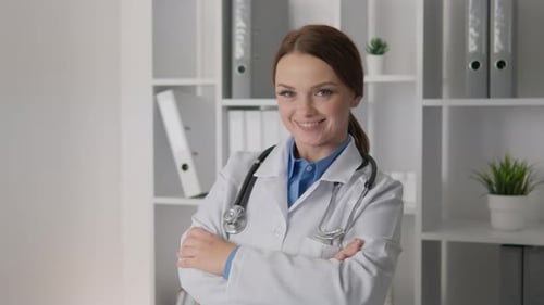 A Doctor in a White Medical Coat with a Stethoscope in Her Office is Ready to Provide Qualified
