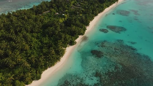 An Aerial Shot Of A Small Rustic Island With A Tropical Forest And Turquoise Sea Water