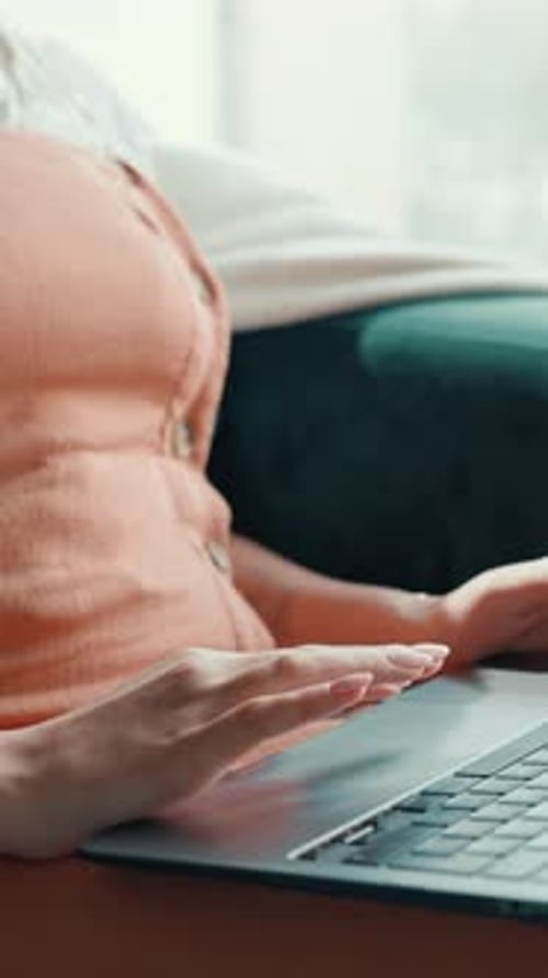 Young Woman Working on Laptop at Home