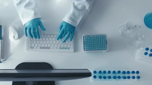 Lab Worker Typing Data on Computer, Scientific Research