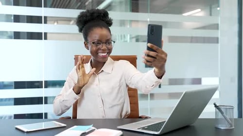 Woman in Office Making Video Call on Phone