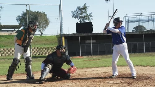 Baseball Player Swinging Bat with Catchers on Field