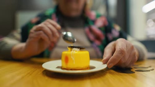 Dessert Enjoyment Share in the Older Woman's Happiness As She Savors Her Dessert the Table Adorned