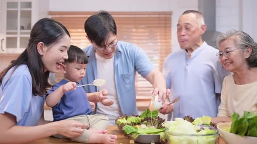 Multi-Generation Family Preparing a Salad in Kitchen