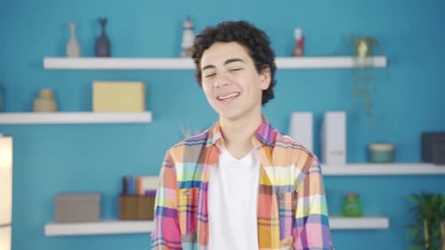 Smiling Teen with Arms Crossed Stands Indoors