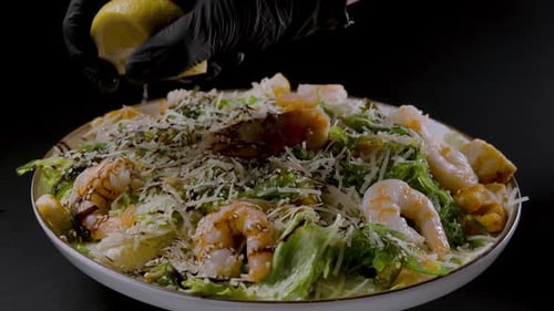 Chef Adding Lemon to Fresh Shrimp Salad