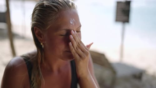 Blonde Caucasian Female Surfer Applying Sunscreen on Her Face Tanned Young Surfing Woman Putting Spf