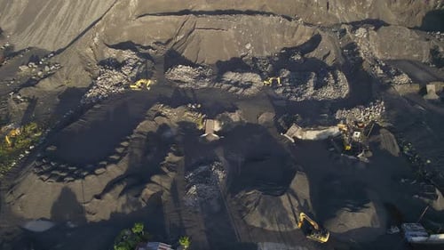 4K aerial footage capturing a sand quarry with excavators at work