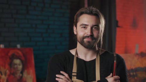 Talented Male Artist Standing with Crossed Arms at Studio