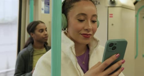 Woman on Subway Train Using Mobile Phone