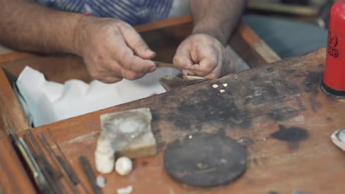 Polishing jewelry by hand in a jewelry workshop 4K