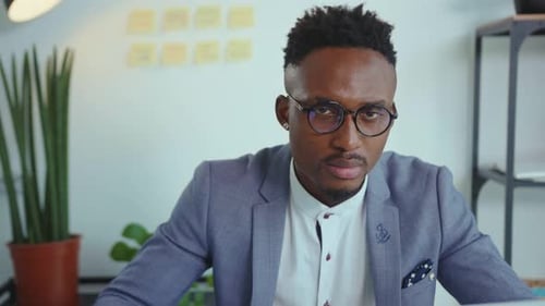 Serious African American Man Look at Camera at Modern Office Use Laptop Technology Professional