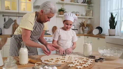 Happy Family in Kitchen Grandmother Granddaughter Child Cutting Cookies of Dough on Kitchen Table