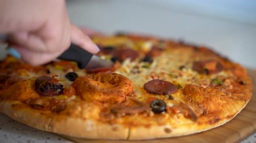 Cutting pizza close up 4K