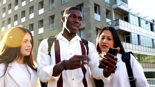 Diverse Friends Using a Smartphone in the City