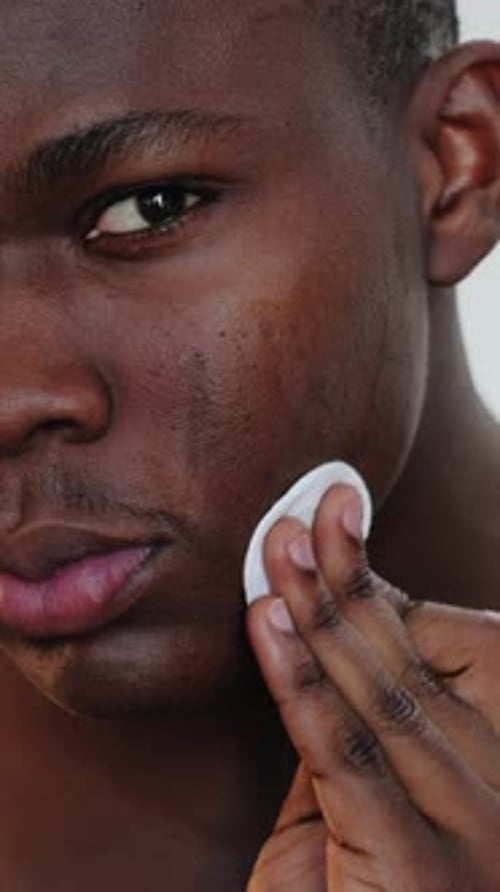 Close Up of Young Adult Cleaning Face