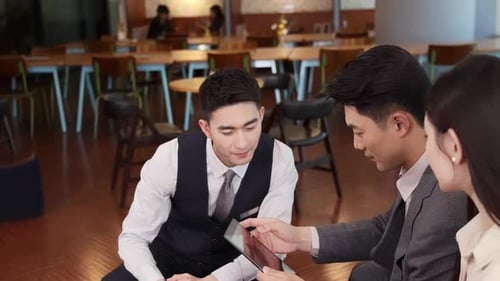 Business Team Discussing Tablet in Modern Urban Office