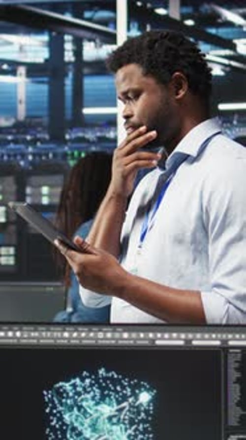 Vertical Video Data Center Engineer Using Tablet to Interpret AI Generated Data Analytics Graphs