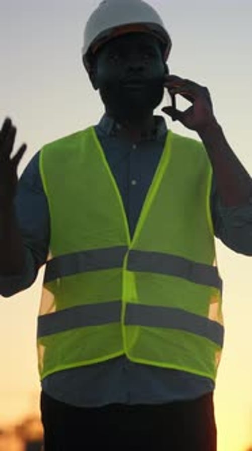 Worried Foreman Calling By Mobile Phone Vertical Portrait of Professional Builder on Construction