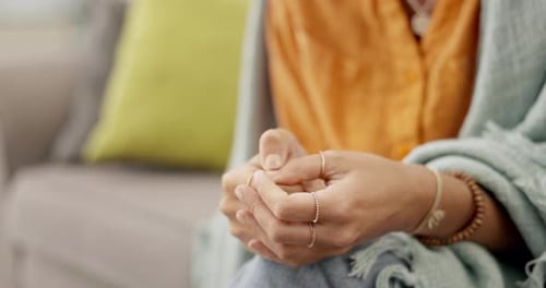 Adult with Clapsed Hands on Sofa Close Up