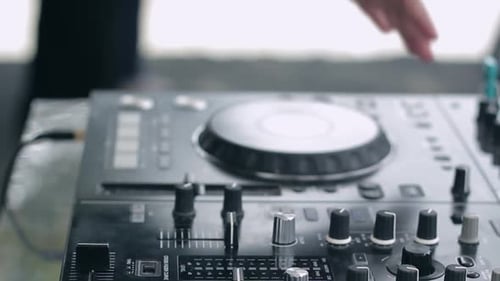 Close up shot DJ hand live perform; turn jog wheel move slidder fadder and switch the knob on dj mix