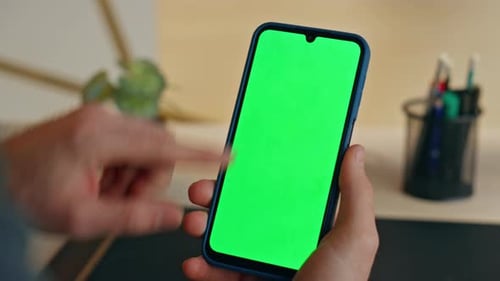 Phone with Green Screen in Hands Close Up