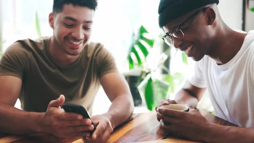 Happy couple of friends, cafe and phone for social media, funny meme and talking
