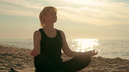Beautiful Free and Wild Woman Sitting in Meditation Pose on Indian Beach Lotus Position Medicine