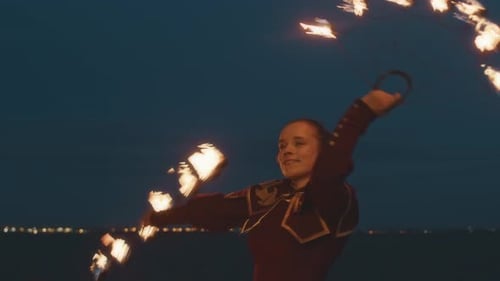 Woman Performing Fire Dance at Night