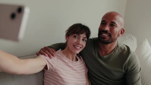 Happy Couple Taking a Selfie on Couch