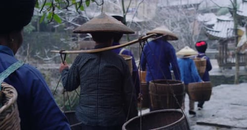 A Group of Chinese Asian Villages Farmers on the Way with Wicker
