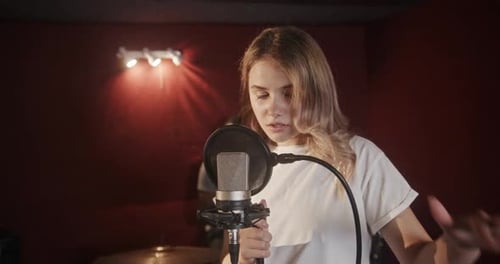 Talented Woman Singing in Recording Studio