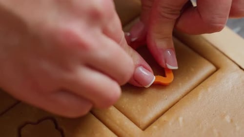 CloseUp of Chef Cutting Strawberry Shape Inside Square Dough for Baking