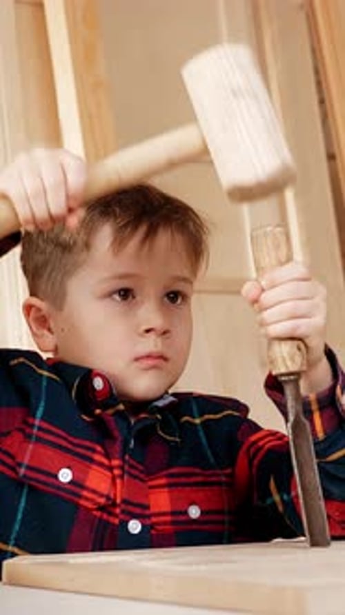 Young Boy Focused on Woodworking Project Using Hammer and Chisel Showcasing Craftsmanship and