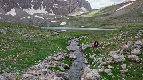 Hiker Tourist Walking Near Mountain Lake