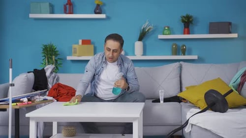 Man Cleaning Table in Living Room