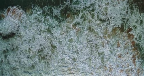 Top Down Drone View of Powerful Ocean Waves Crashing on Shore