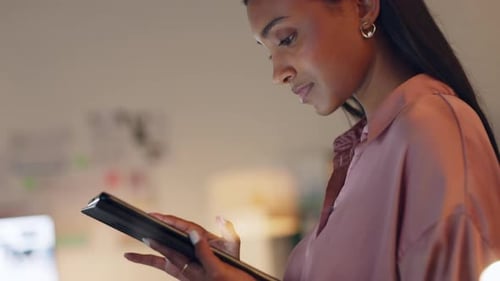 Young Woman Using Tablet in Modern Office