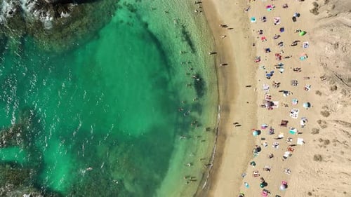 Aerial view of sandy beach and turquoise water, Spain.