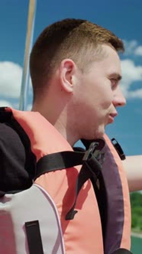 Man Wearing Life Vest with Blue Sky Background