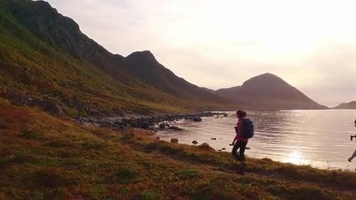 Hikers enjoying a peaceful adventure on a coastal trail in Vestarelen, Norway
