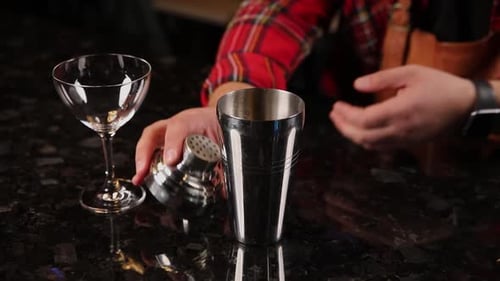the bartender prepares a cocktail at the bar