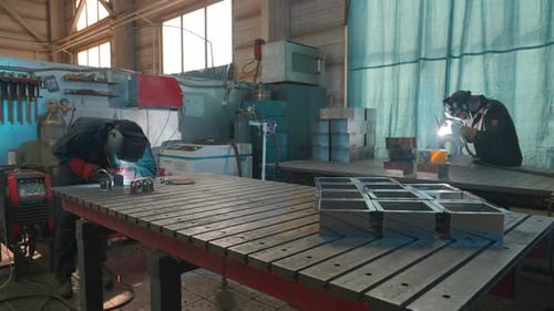 Skilled Welders Working Diligently in an Industrial Workshop