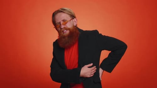 Red Bearded Man with Side Pain on Orange Background
