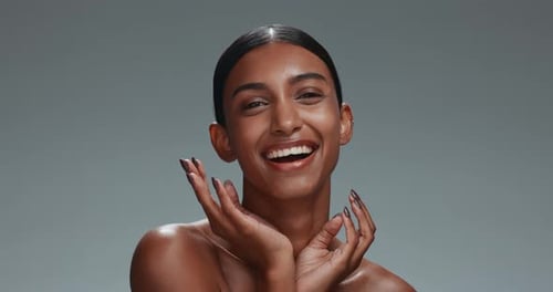 Face, skincare hand and beauty of woman in studio isolated on a gray background