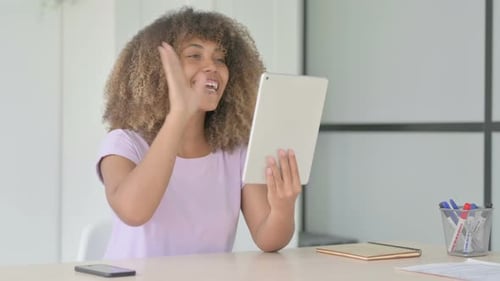 Woman Video Conferencing On Tablet Device Indoors